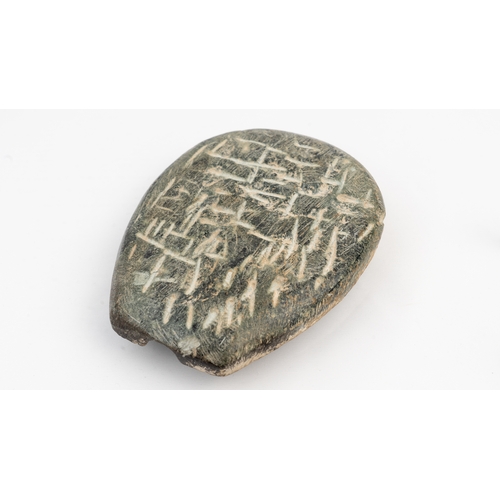 7 - A SELJUK INSCRIBED SCHIST CASTING MOULD 
PERSIA, 
12TH CENTURY.  Of teardrop form, raised central bo... 