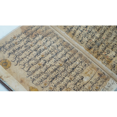 8 - A RARE QUR’AN SECTION,
YEMEN/ IRAQ, 11TH CENTURY.  Arabic manuscript on paper, 18 lines of bold blac... 