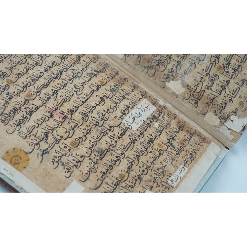 8 - A RARE QUR’AN SECTION,
YEMEN/ IRAQ, 11TH CENTURY.  Arabic manuscript on paper, 18 lines of bold blac... 