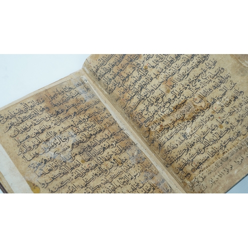 8 - A RARE QUR’AN SECTION,
YEMEN/ IRAQ, 11TH CENTURY.  Arabic manuscript on paper, 18 lines of bold blac... 