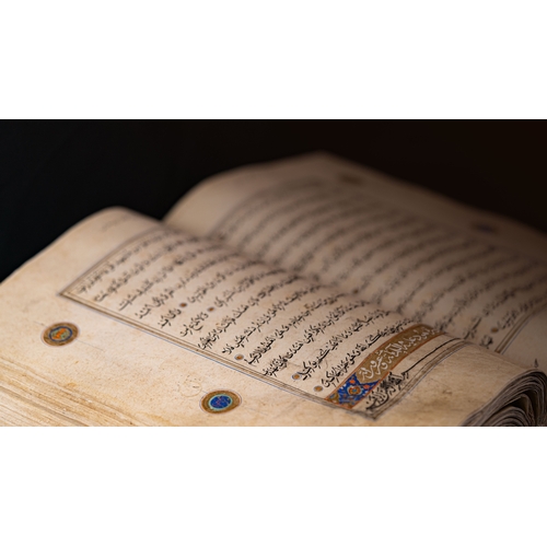 15 - A MASSIVE HERAT QUR’AN   Arabic manuscript on paper, 14 lines of black naskh script,lobbed gold rpou... 