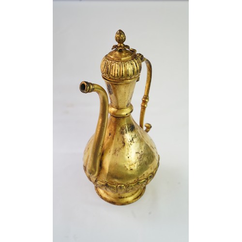 77 - A GILT-COPPER (TOMBAK) EWER
OTTOMAN   Of pyriform form, the tombak ewer on a splayed rounded foot, t... 