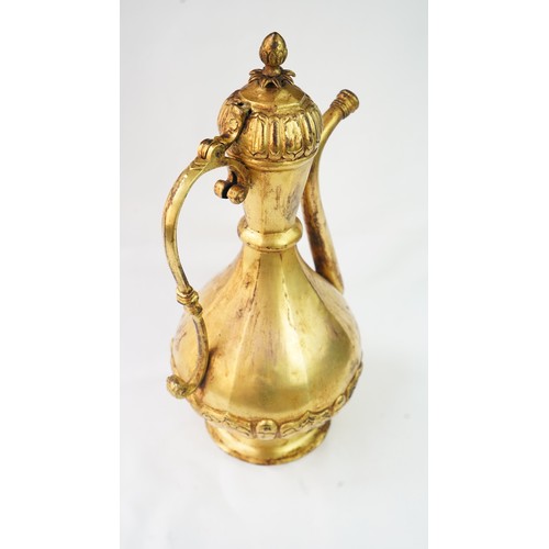 77 - A GILT-COPPER (TOMBAK) EWER
OTTOMAN   Of pyriform form, the tombak ewer on a splayed rounded foot, t... 