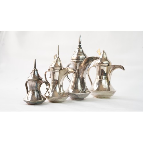 80 - A SET OF FOUR IRAQ SILVER DALLAH COFFEE POTS   Of traditional shapes, silver coffee pots with long s... 