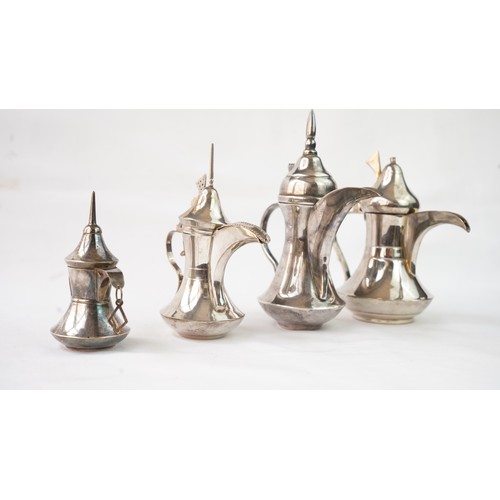 80 - A SET OF FOUR IRAQ SILVER DALLAH COFFEE POTS   Of traditional shapes, silver coffee pots with long s... 