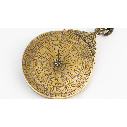 83 - A QAJAR BRASS ASTROLABE
18TH CENTURY
DATED 1186AH/1772 AD
SIGNED   Of typical circular shape, compri... 