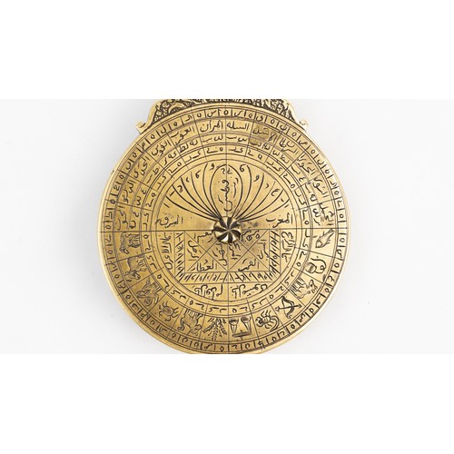 83 - A QAJAR BRASS ASTROLABE
18TH CENTURY
DATED 1186AH/1772 AD
SIGNED   Of typical circular shape, compri... 