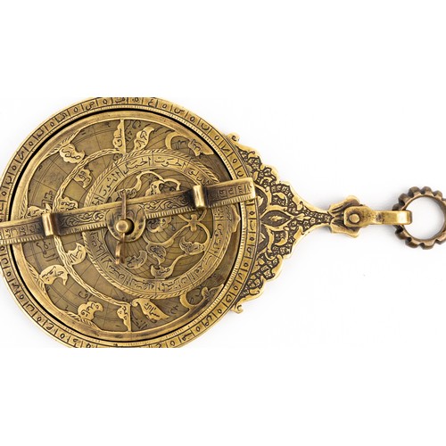 83 - A QAJAR BRASS ASTROLABE
18TH CENTURY
DATED 1186AH/1772 AD
SIGNED   Of typical circular shape, compri... 