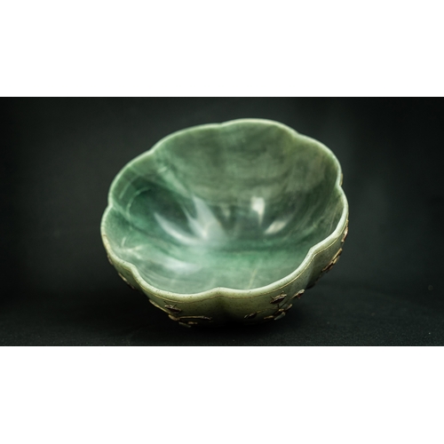 105 - A GREEN JADE POLY-LOBED GEMSET BOWL, INDIA
Of poly-lobed form, resting on a short circular foot, car... 