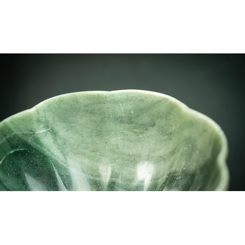 105 - A GREEN JADE POLY-LOBED GEMSET BOWL, INDIA
Of poly-lobed form, resting on a short circular foot, car... 