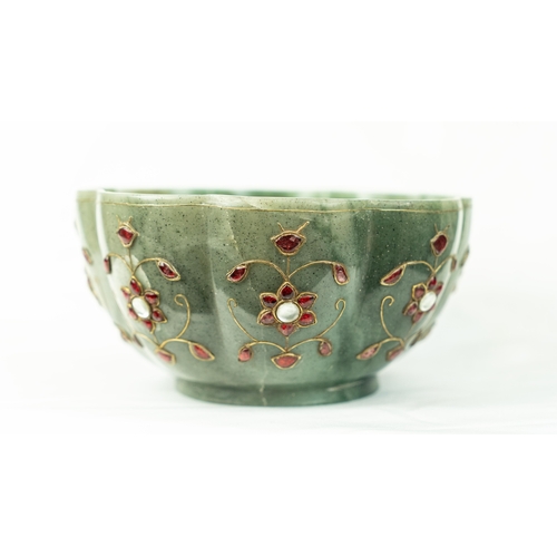 105 - A GREEN JADE POLY-LOBED GEMSET BOWL, INDIA
Of poly-lobed form, resting on a short circular foot, car... 