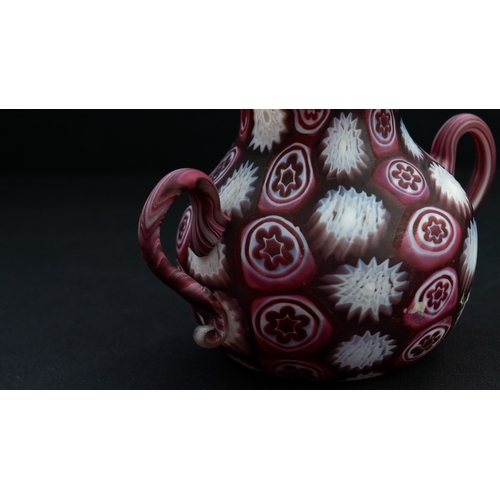 113 - A FRATELLI TOSO MURANO MILLEFIORI TINY VASE
Of bulbous form, resting on a flat base, two S-scroll ha... 