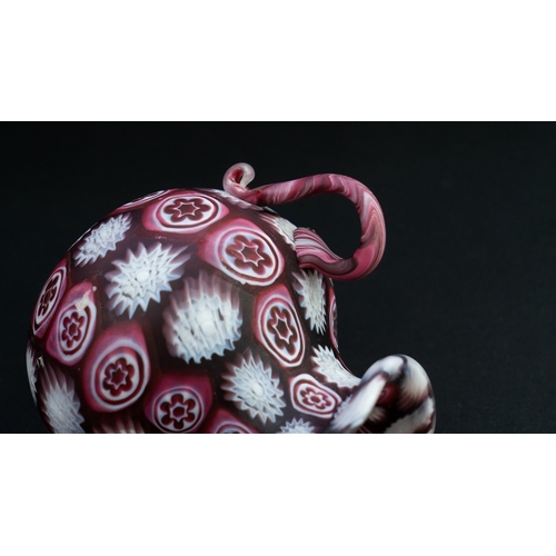 113 - A FRATELLI TOSO MURANO MILLEFIORI TINY VASE
Of bulbous form, resting on a flat base, two S-scroll ha... 