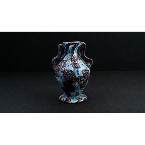 115 - A FRATELLI TOSO MURANO MILLEFIORI TINY VASE
Of traditional amphora shape, resting on a circular spla... 