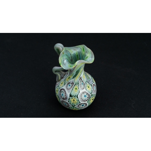 119 - A FRATELLI TOSO MURANO MILLEFIORI VASE
Of baluster shape, resting on a flat base, with a tall cylind... 