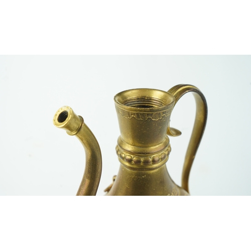 128 - A GILT-COPPER (TOMBAK) ZAM ZAM EWER
OTTOMAN
Of pyriform form, the tombak ewer on a splayed rounded f... 