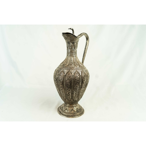 63 - AN ANGLO-INDIAN SILVER-PLATED COPPER CLARET JUG, INDIA, LATE 19TH CENTURY, RAJ PERIOD. Of lobed form... 