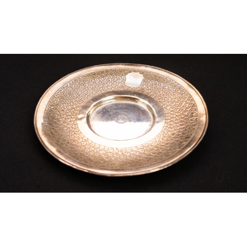 68 - A SILVER DISH , SAUCER  
Of circular form, the edge engraved with a wide band in scalloped design, a... 