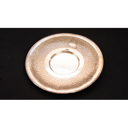 68 - A SILVER DISH , SAUCER  
Of circular form, the edge engraved with a wide band in scalloped design, a... 