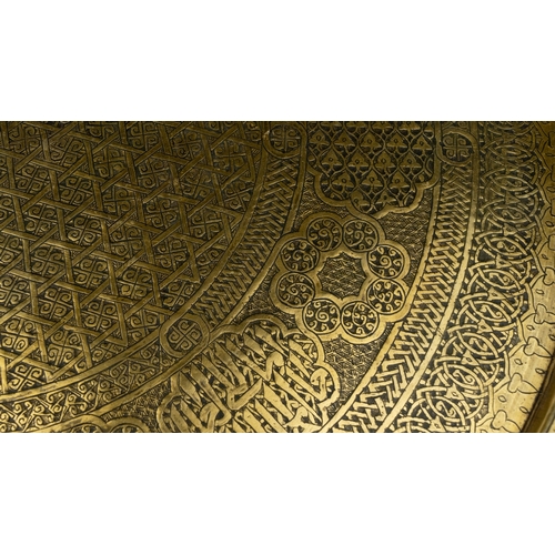 75 - A LARGE BRASS TRAY
Of large circular form, resting on a flat, plain base, rising to a flattened, eve... 