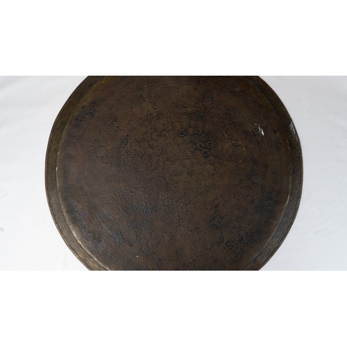 75 - A LARGE BRASS TRAY
Of large circular form, resting on a flat, plain base, rising to a flattened, eve... 