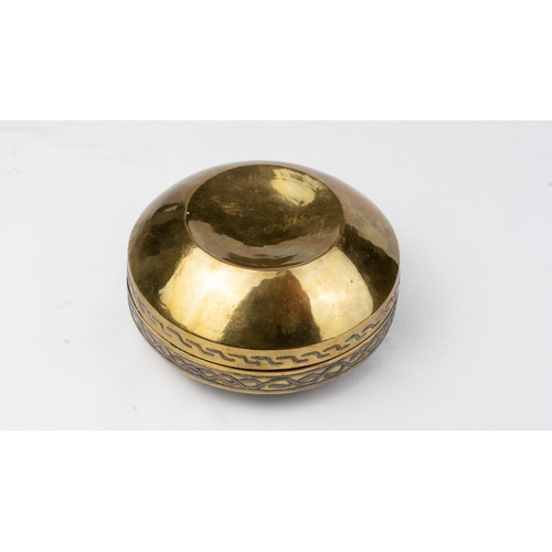 78 - A ROUND SILVER-INLAID BRASS BOX
Of rounded form resting on a plain surface, with a pull-off lid, the... 