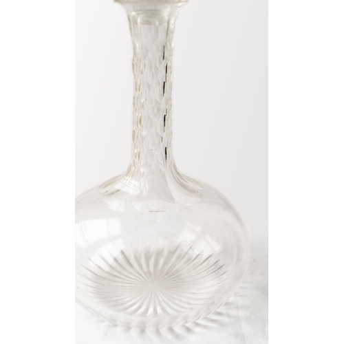 86 - A CUT GLASS DECANTER
Of bulbous form, resting a flat base and a star cut base, diamond facet cuts on... 