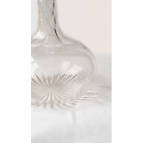 86 - A CUT GLASS DECANTER
Of bulbous form, resting a flat base and a star cut base, diamond facet cuts on... 