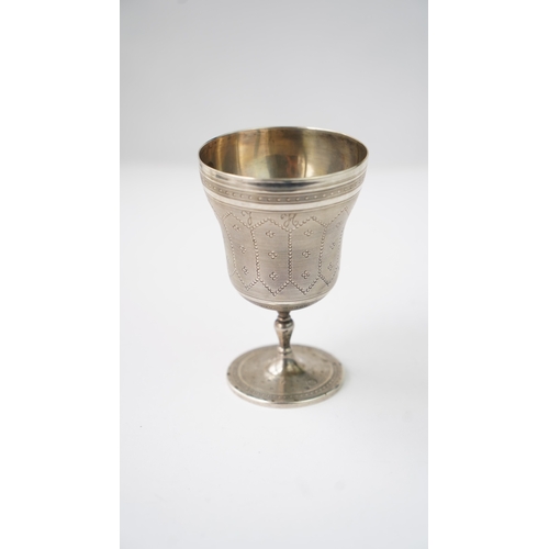 11 - A SILVER CUP Of flaring form, resting upon baluster stem with a flat circular foot, the exterior in ... 