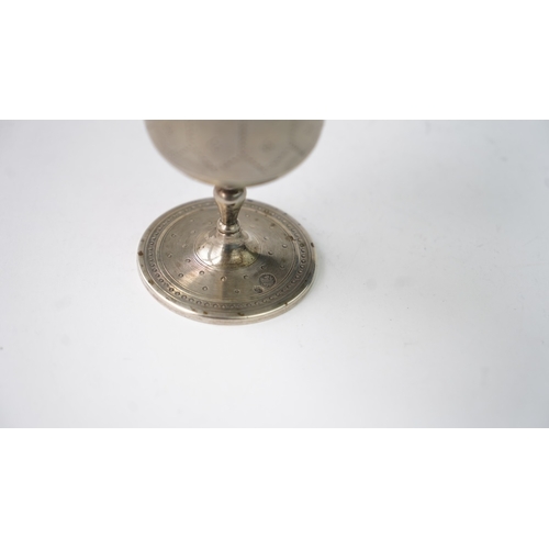 11 - A SILVER CUP Of flaring form, resting upon baluster stem with a flat circular foot, the exterior in ... 