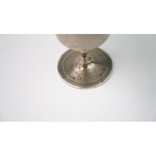 11 - A SILVER CUP Of flaring form, resting upon baluster stem with a flat circular foot, the exterior in ... 