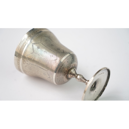 11 - A SILVER CUP Of flaring form, resting upon baluster stem with a flat circular foot, the exterior in ... 