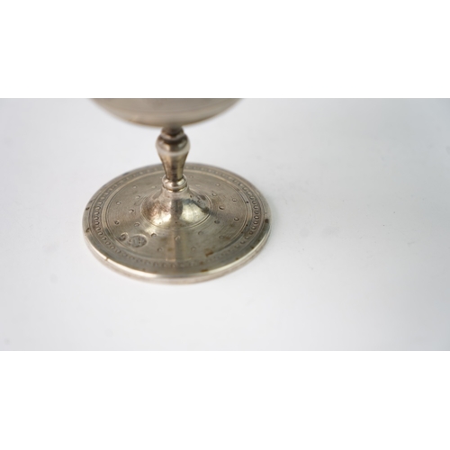 11 - A SILVER CUP Of flaring form, resting upon baluster stem with a flat circular foot, the exterior in ... 