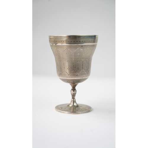 11 - A SILVER CUP Of flaring form, resting upon baluster stem with a flat circular foot, the exterior in ... 