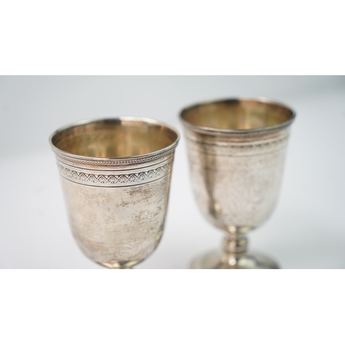 12 - A PAIR OF SILVER CUPS Of rounded circular form, rising from a splayed foot, the body with a palmette... 