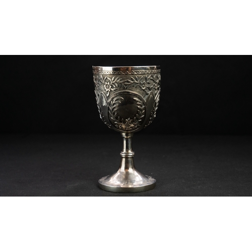 14 - A SILVER REPOUSSE GOBLET Of rounded circular form upon a stem with a central knop, resting on a spre... 