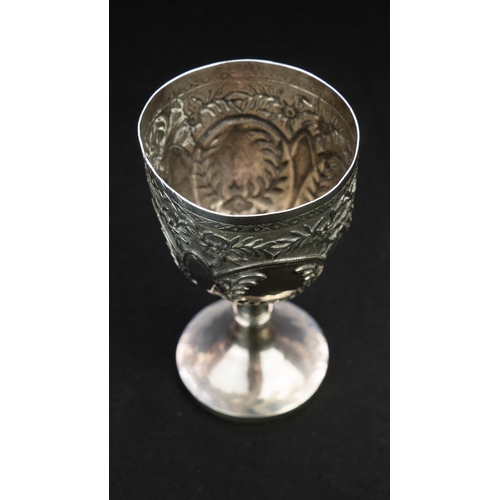 14 - A SILVER REPOUSSE GOBLET Of rounded circular form upon a stem with a central knop, resting on a spre... 