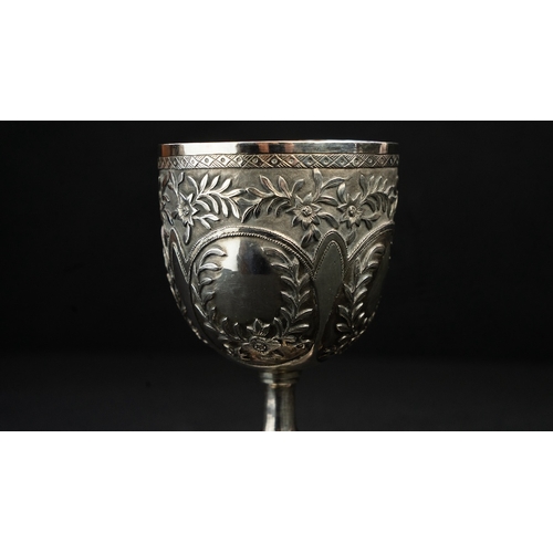 14 - A SILVER REPOUSSE GOBLET Of rounded circular form upon a stem with a central knop, resting on a spre... 