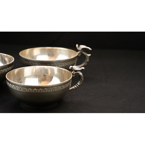 18 - A SET OF SILVER WATER CUPS Of inverted baluster circular form, resting on a flat base, S-scroll hand... 