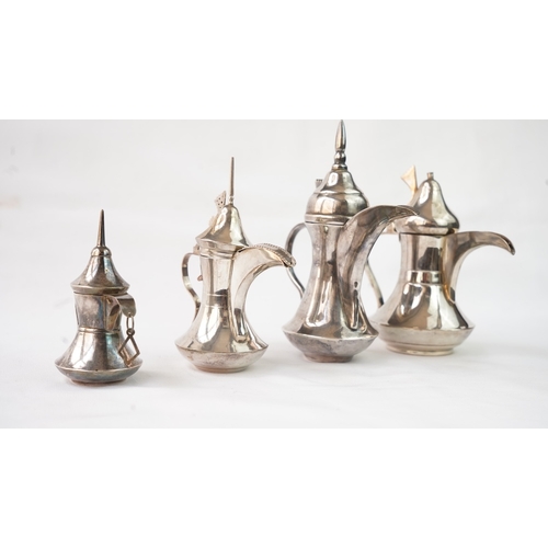 27 - A SET OF FOUR IRAQ SILVER DALLAH COFFEE POTS Of traditional shapes, silver coffee pots with long spo... 