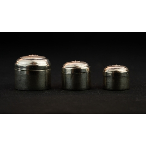 31 - THREE SILVER TRINKET BOXES Of cylindrical shape with a domed and pull-off lid, the centre of the lid... 