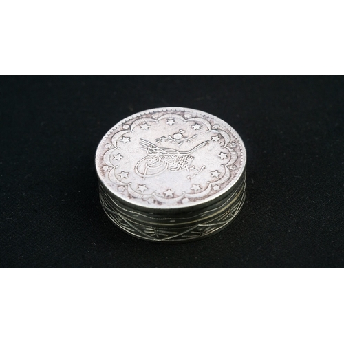 35 - A SILVER TRINKET BOX WITH A TUGHRA Of rounded form, resting on a flat base, the lid with an Ottoman ... 