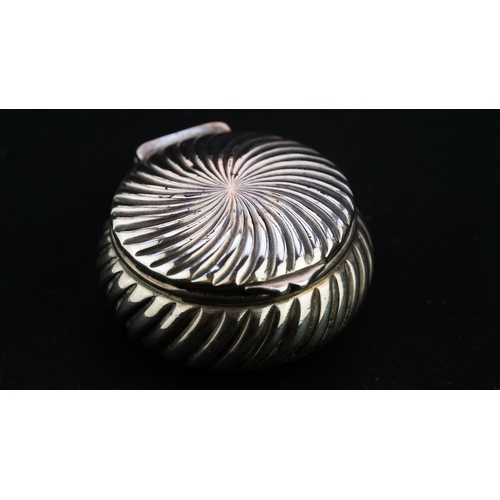 36 - A SILVER CLAM SHELL-SHAPED TRINKET BOX 
Of circular form, with a hinged lid, featuring repetitive an... 