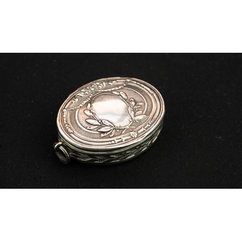 39 - A SILVER PENDANT WITH A HINGED LID  Of oval form, with a hinged lid, featuring a vacant laurel wreat... 