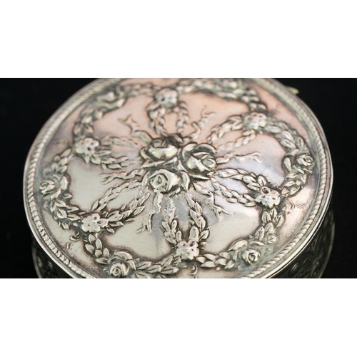 43 - A ROUND TRINKET SILVER BOX Of rounded form, the hinged lid embossed with six intertwined wreathes em... 