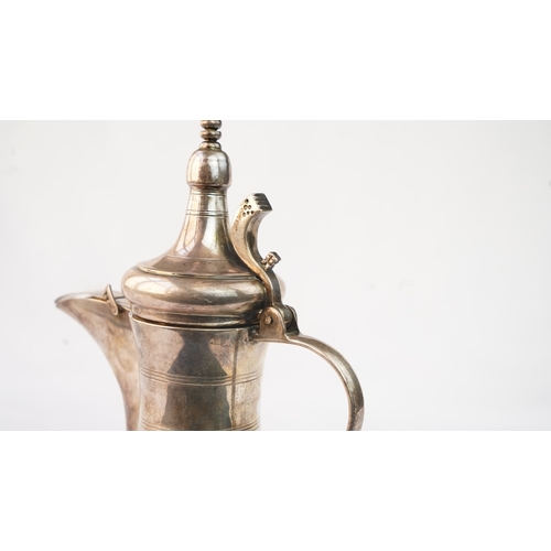 48 - A SILVER ARABIC COFFEE POT, MIDDLE EAST, OMAN Of traditional shape, a silver coffee pot with a long ... 