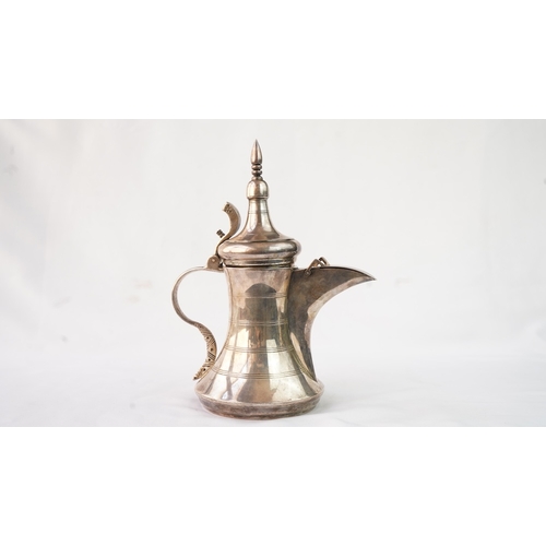 48 - A SILVER ARABIC COFFEE POT, MIDDLE EAST, OMAN Of traditional shape, a silver coffee pot with a long ... 