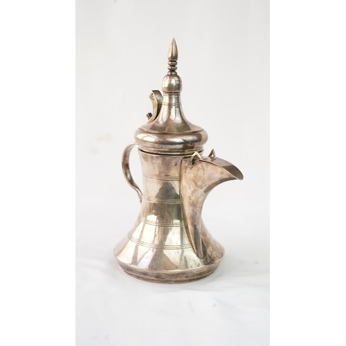 48 - A SILVER ARABIC COFFEE POT, MIDDLE EAST, OMAN Of traditional shape, a silver coffee pot with a long ... 