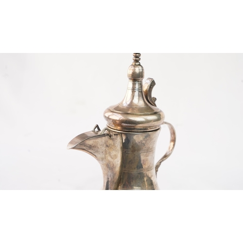 48 - A SILVER ARABIC COFFEE POT, MIDDLE EAST, OMAN Of traditional shape, a silver coffee pot with a long ... 