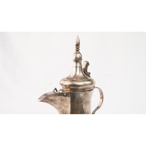 48 - A SILVER ARABIC COFFEE POT, MIDDLE EAST, OMAN Of traditional shape, a silver coffee pot with a long ... 